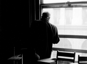 Leon Stein, looks out the window of an NYU classroom in the building which housed the Triangle Waist Company